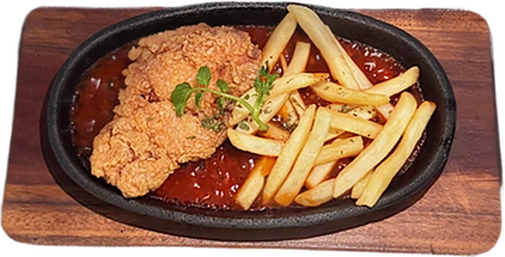 Crispy chicken steak on a cast-iron skillet